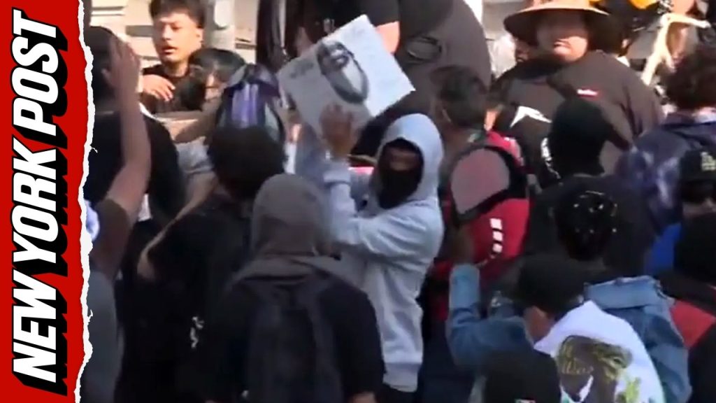 Anti-ICE Rioters Caught-On-Camera Handing Out Tactical Gear and Masks in Clash with Cops